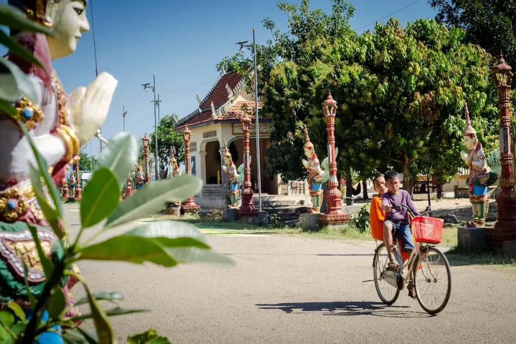 children-cycling-at-wat-svay-andet-temple-gardens