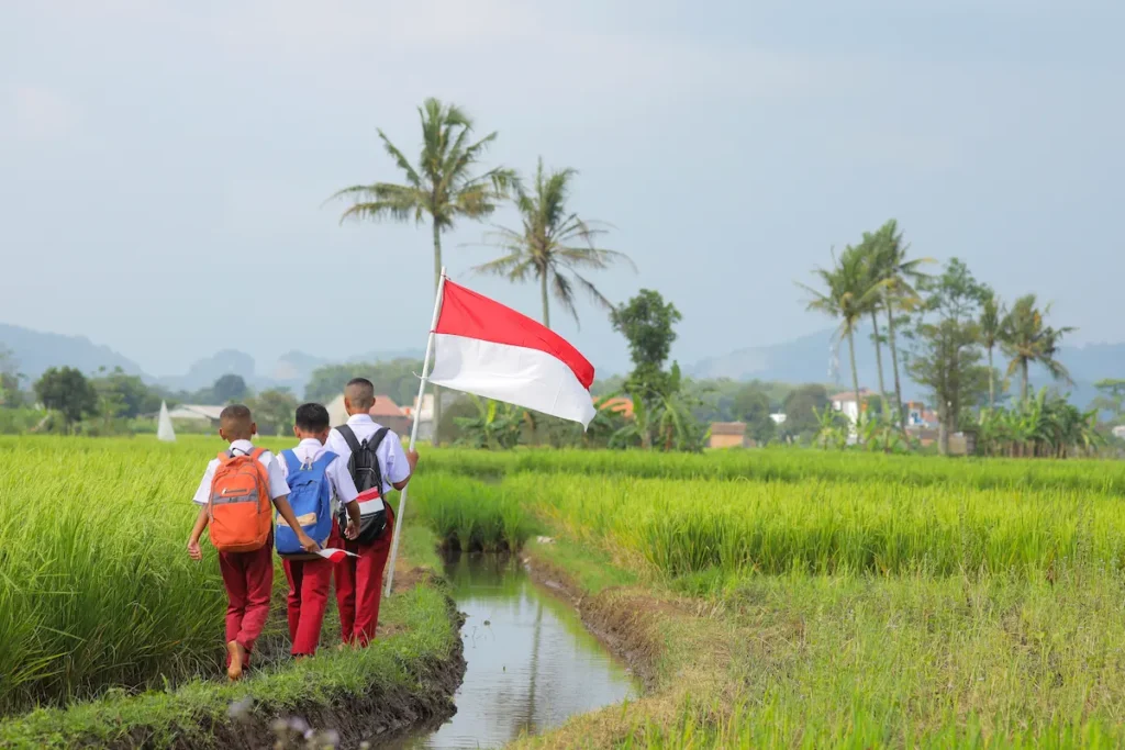 children-with-backpacks-walking-in-green-rural