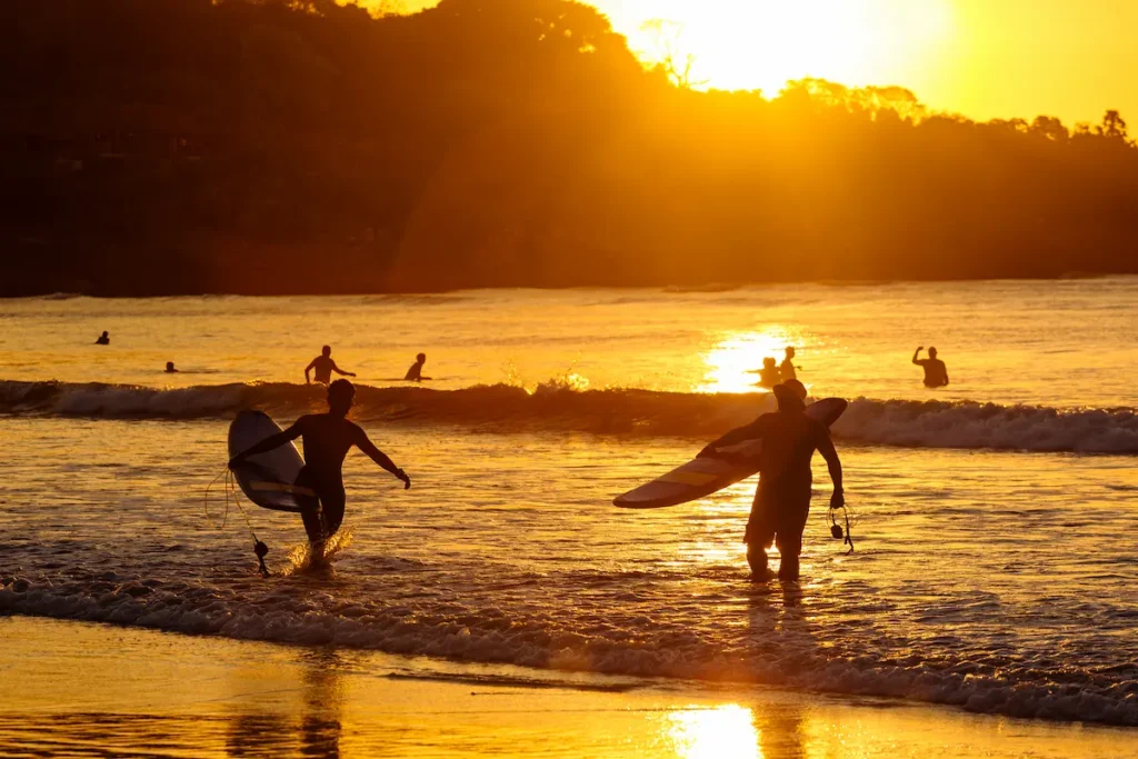 surfers-at-sunset-on-the-beach