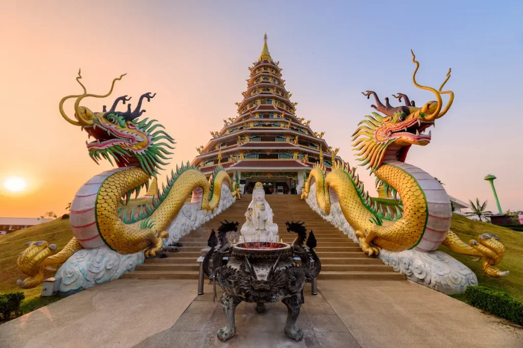 the-dragons-statue-is-between-the-pagoda-at-sunset