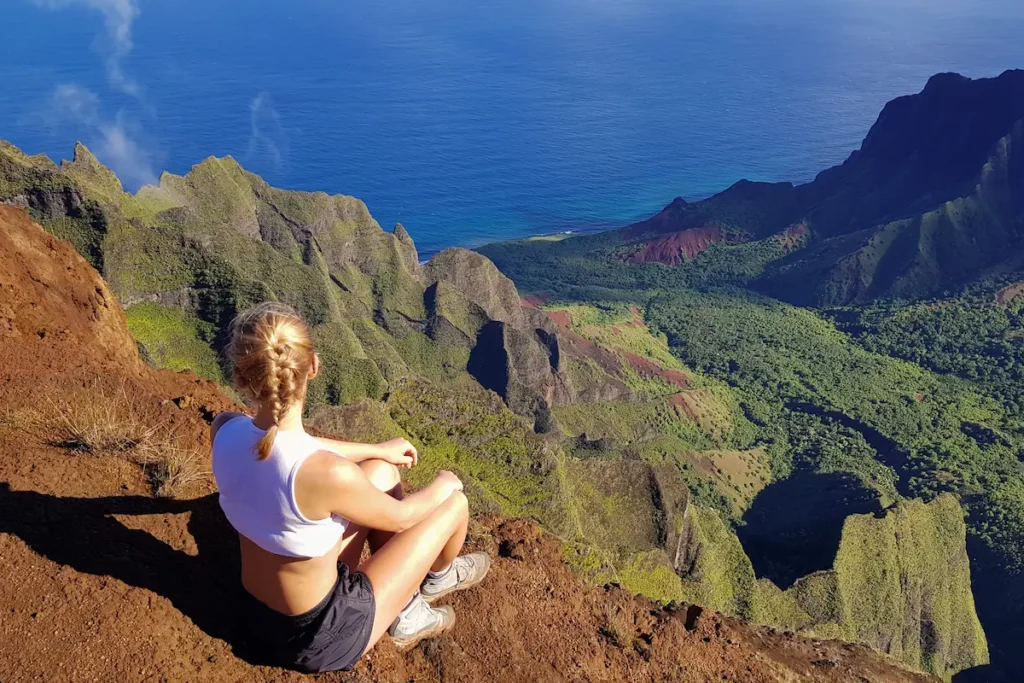 woman-sitting-on-the-mountain-ridge