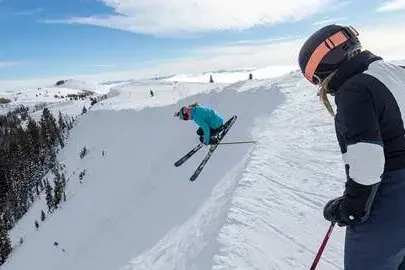 empire-pass-guests-skiing-off-top-of-ski-run.jpg